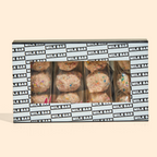 A front view of the birthday cake truffle dozen box with individually wrapped truffle 3-packs inside.